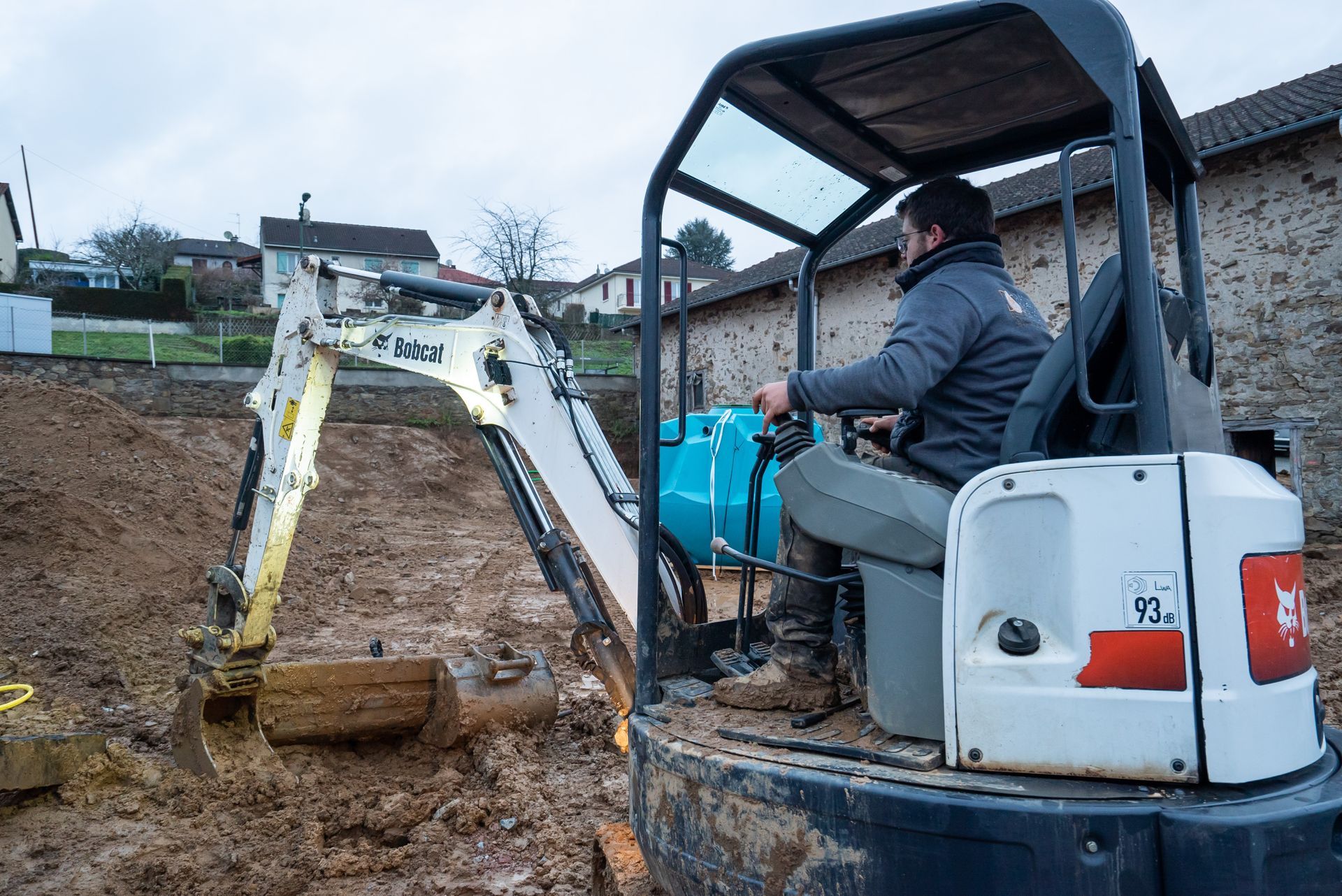Ouvrier Domélec dans une minipelle creusant une tranchée