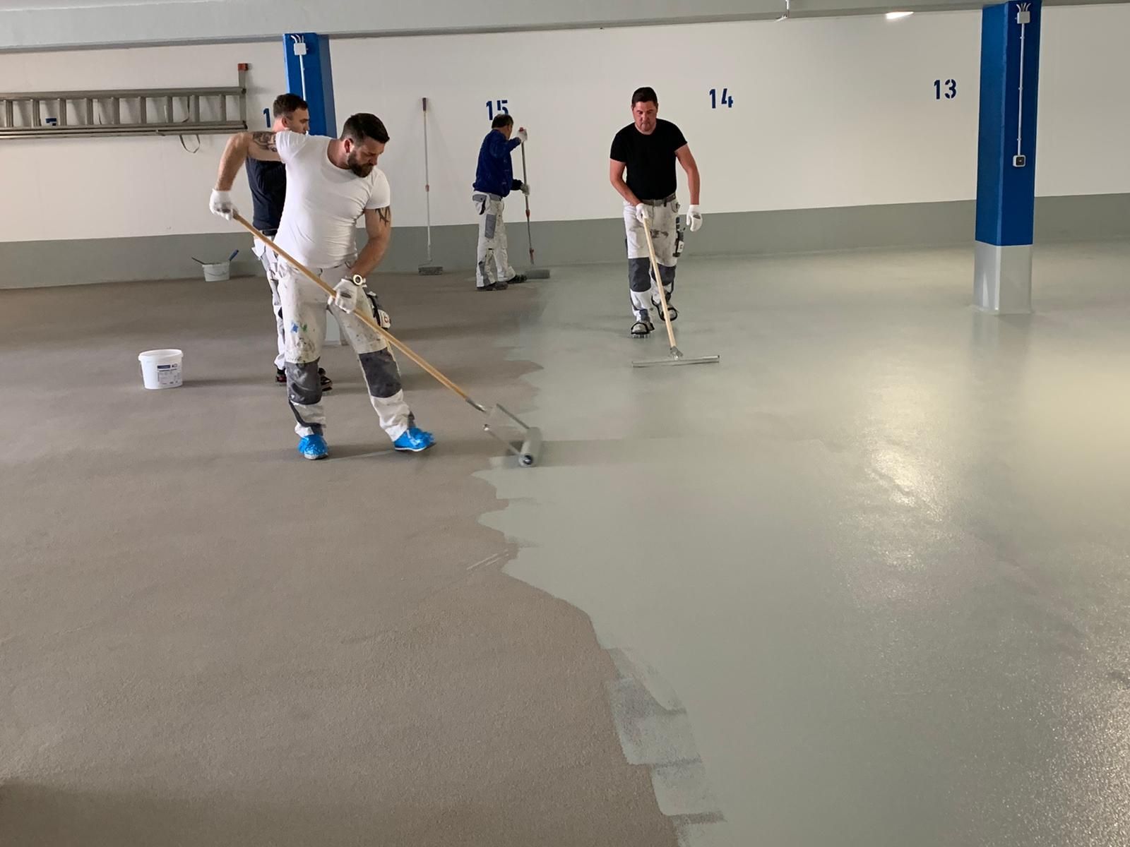 Team bei großflächigen Bodenbeschichtungsarbeiten.