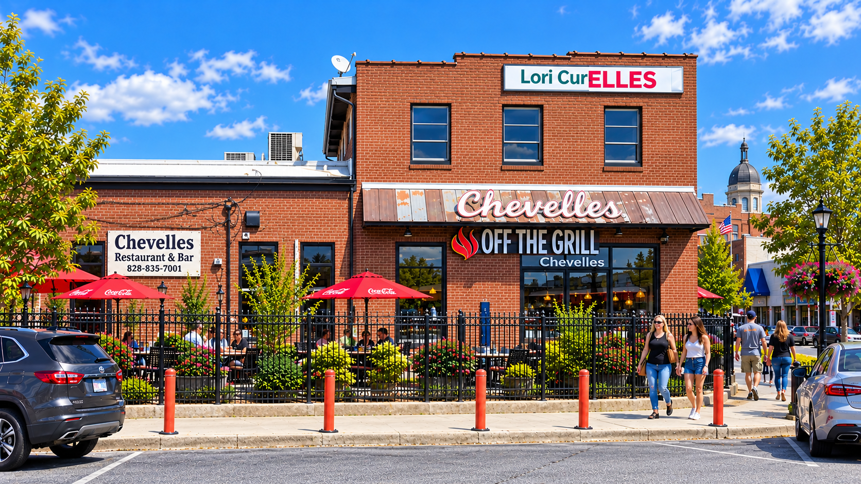 Brick gift shop storefront with colorful awnings, plants, and parked cars on a sunny street
