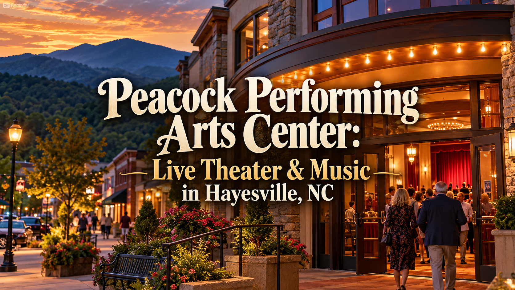 Peacock Performing Arts Center at dusk, with warm-lit theater entrance and mountains in Hayesville, NC.