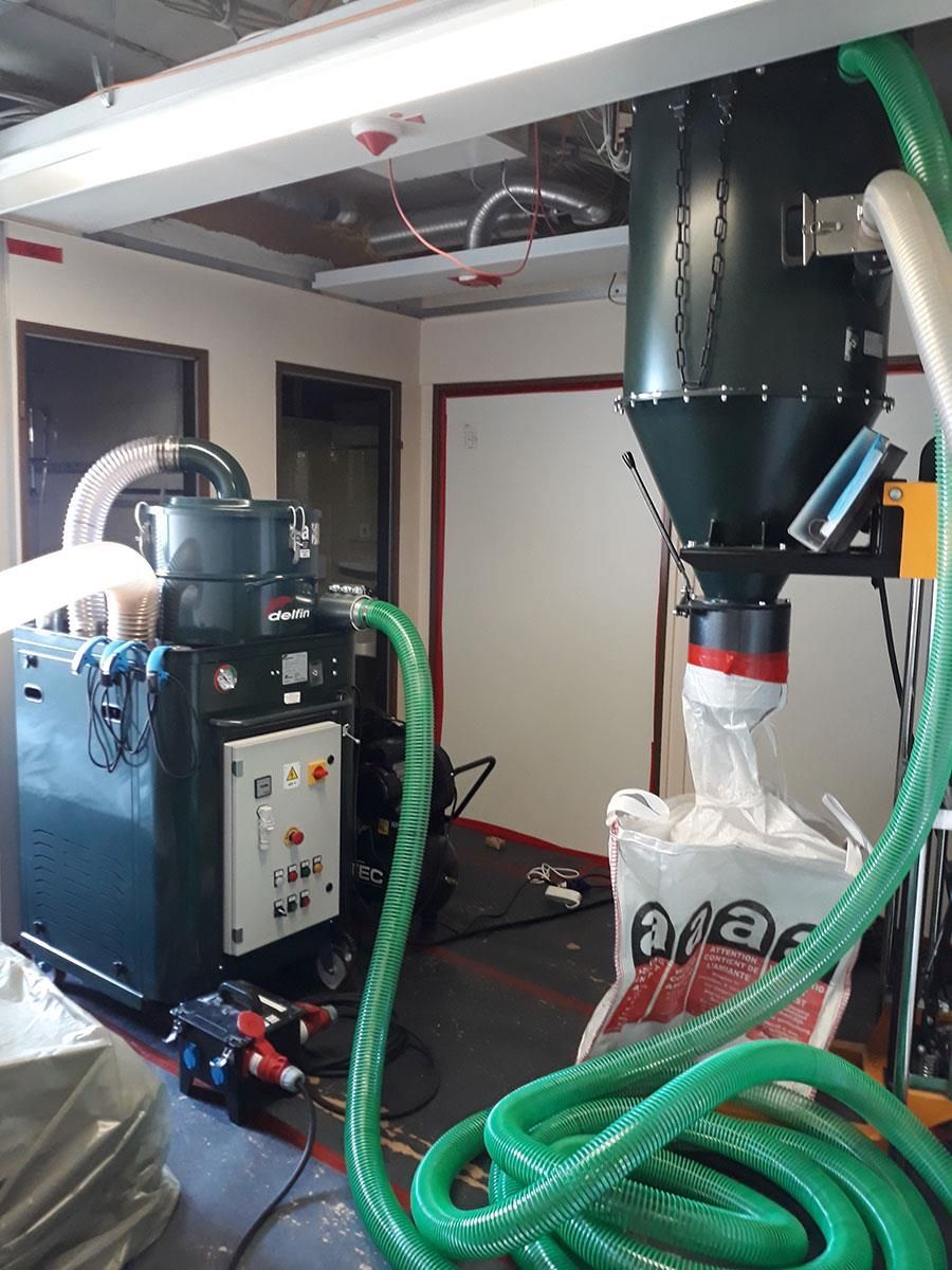 Ein grüner Schlauch ist an einer Maschine in einem Raum angeschlossen.