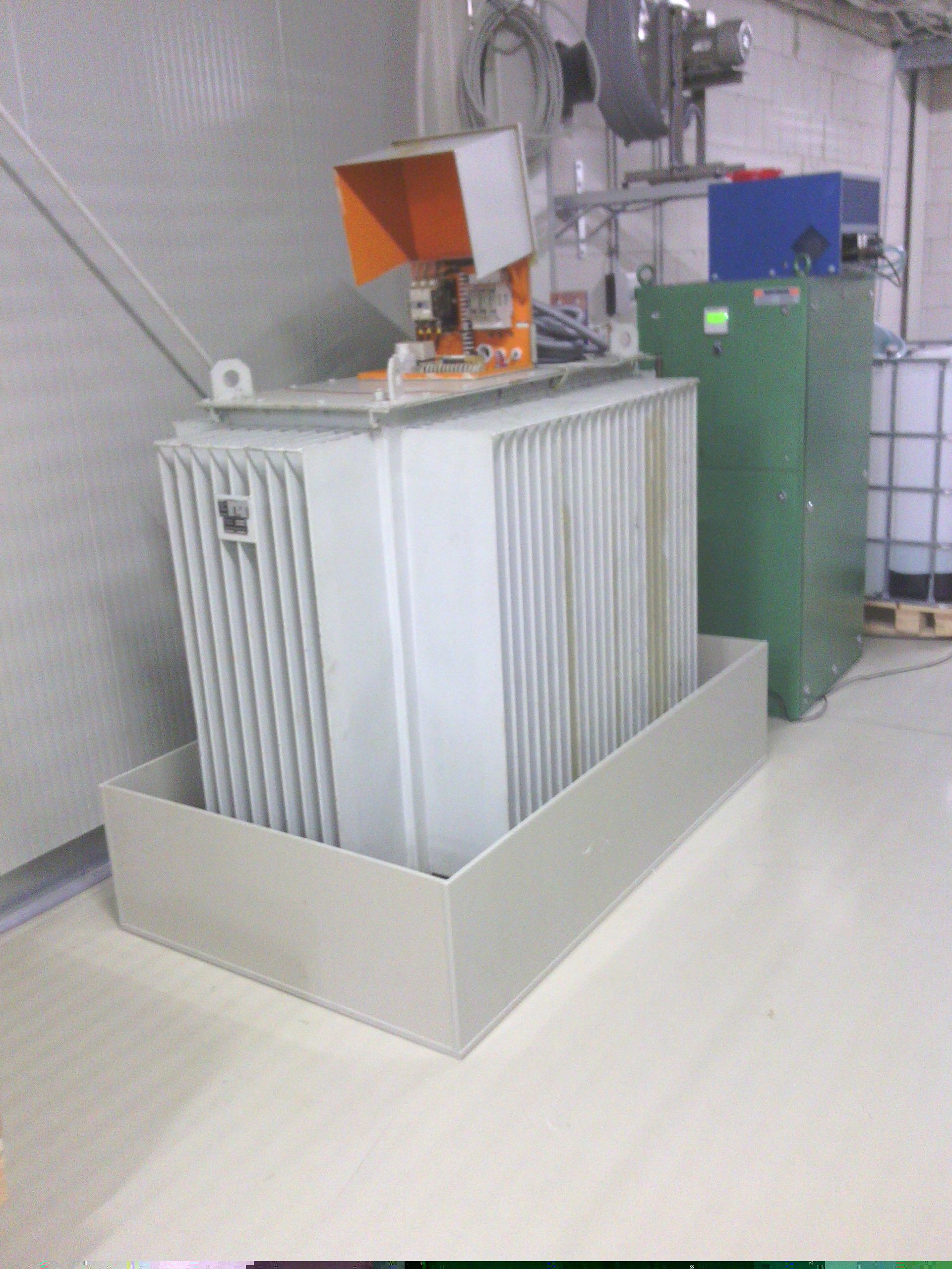 Ein Transformator liegt in einer Kiste auf dem Boden