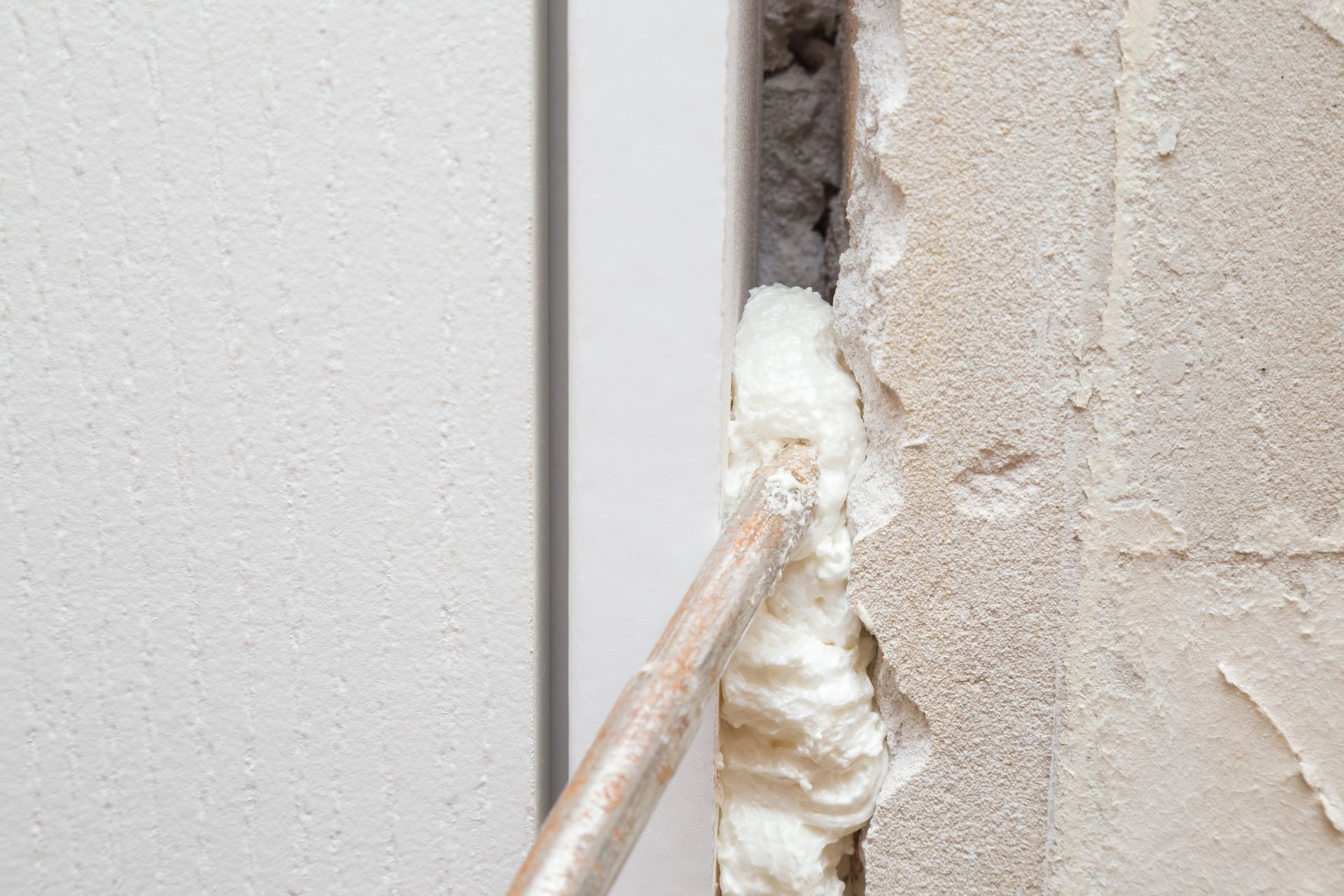 Application d'un mastic expansif en mousse pour combler les espaces entre les blocs de construction.