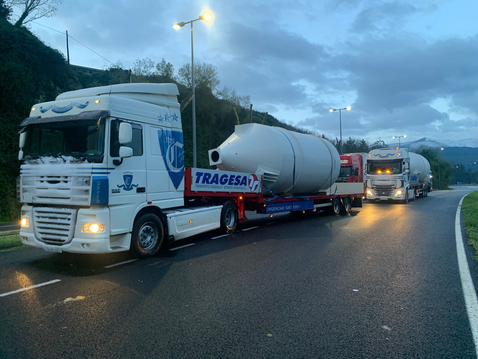 Un camión blanco con la palabra tragedia en el costado circula por una carretera.