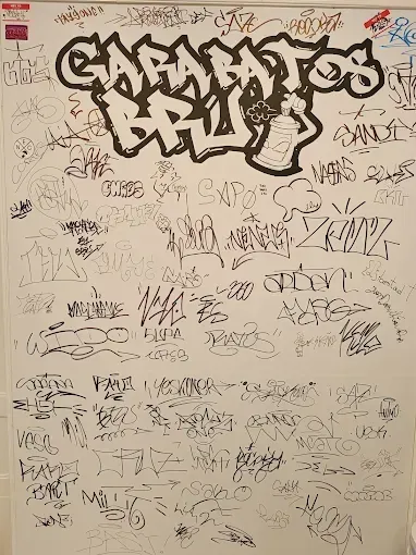 Una pizarra blanca con muchos grafitis.