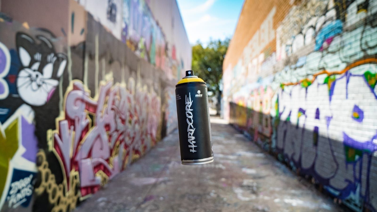 Una lata de pintura en aerosol está en el medio de un callejón estrecho.
