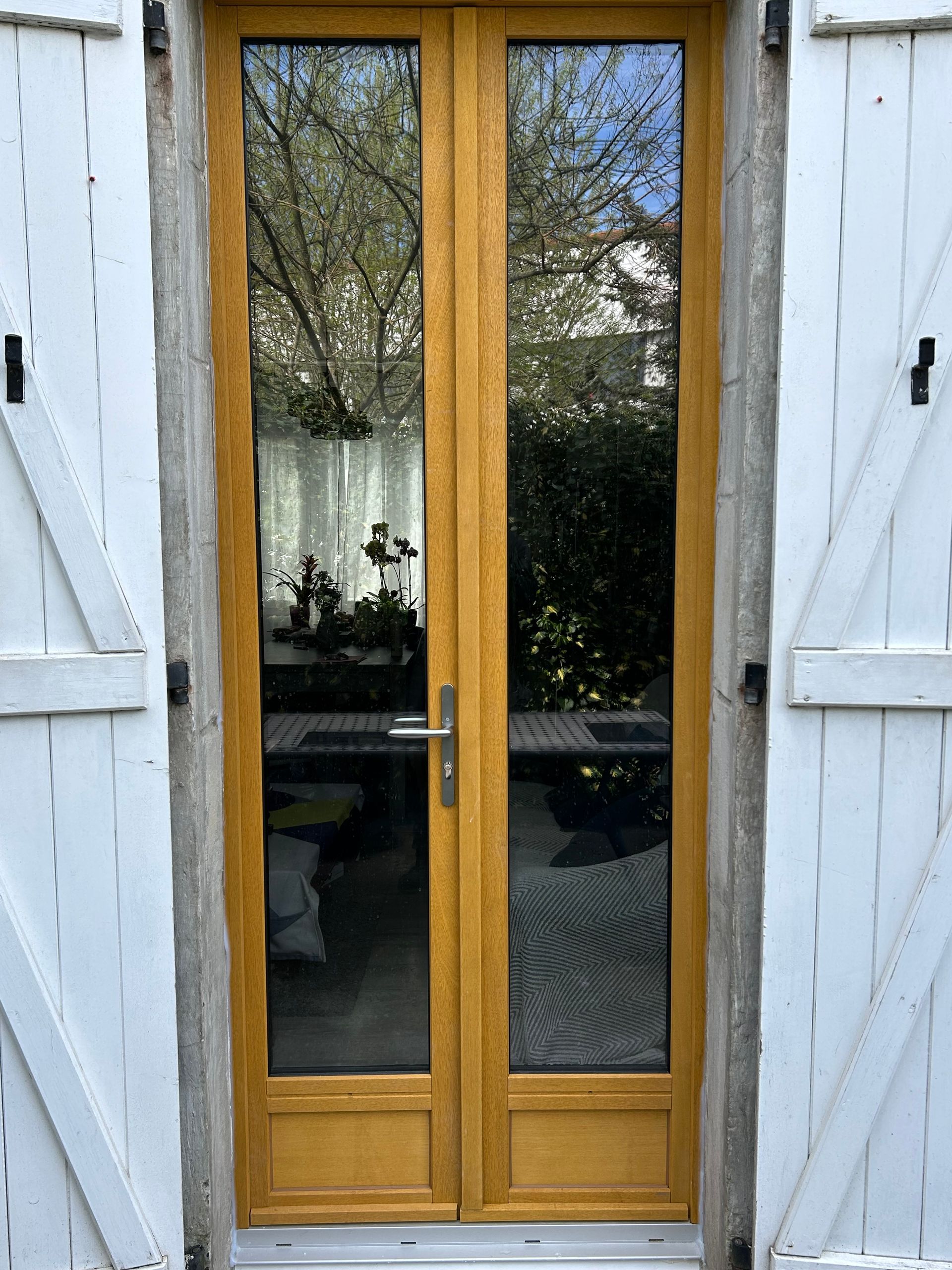 porte fenêtre en bois avec volets blancs
