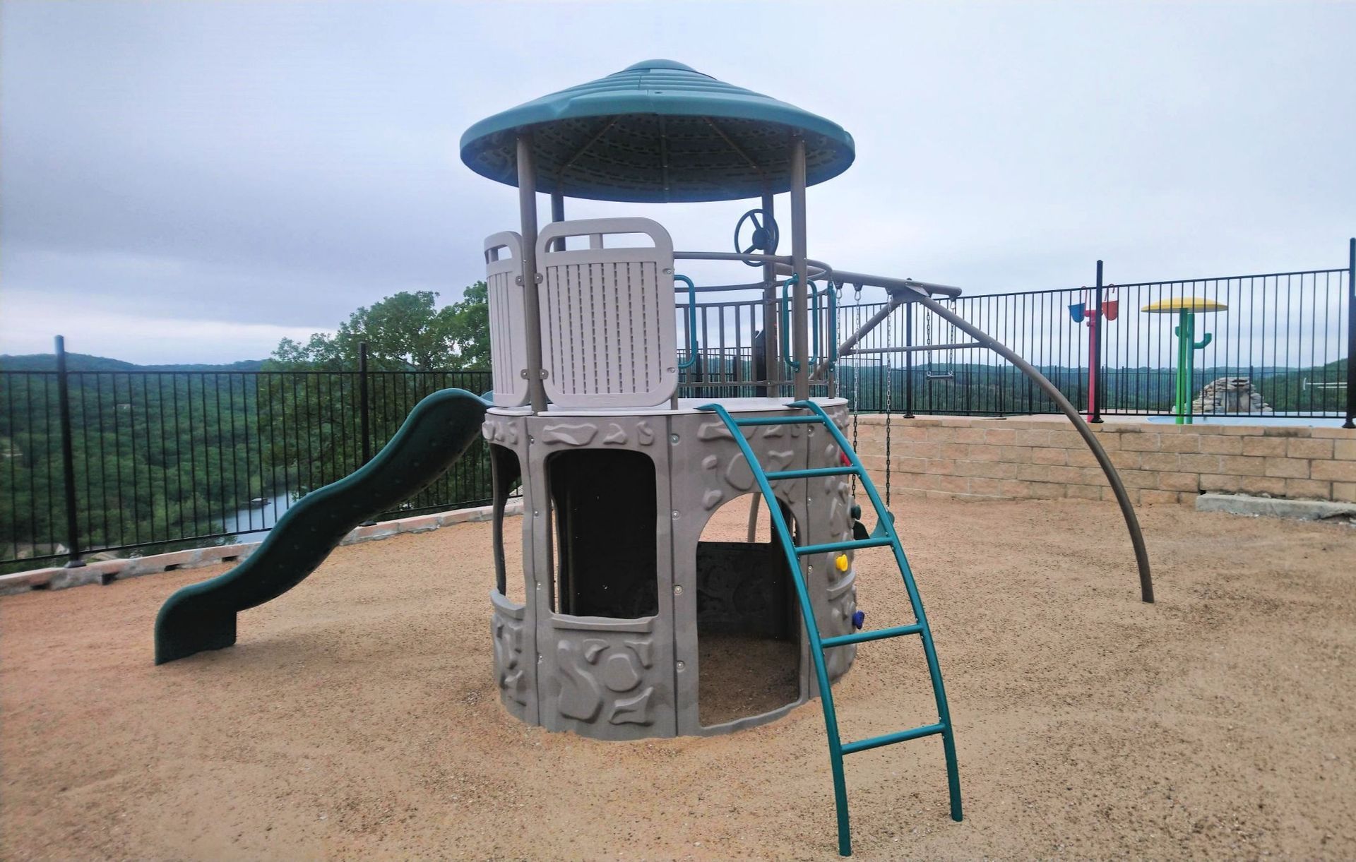 Enclosed playground with rubber mulch for the little ones !