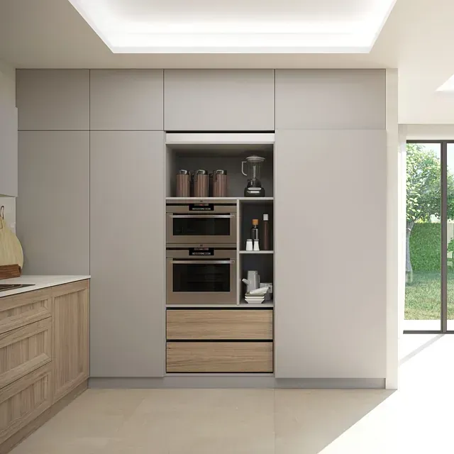 Una cocina con gabinetes blancos y cajones de madera.