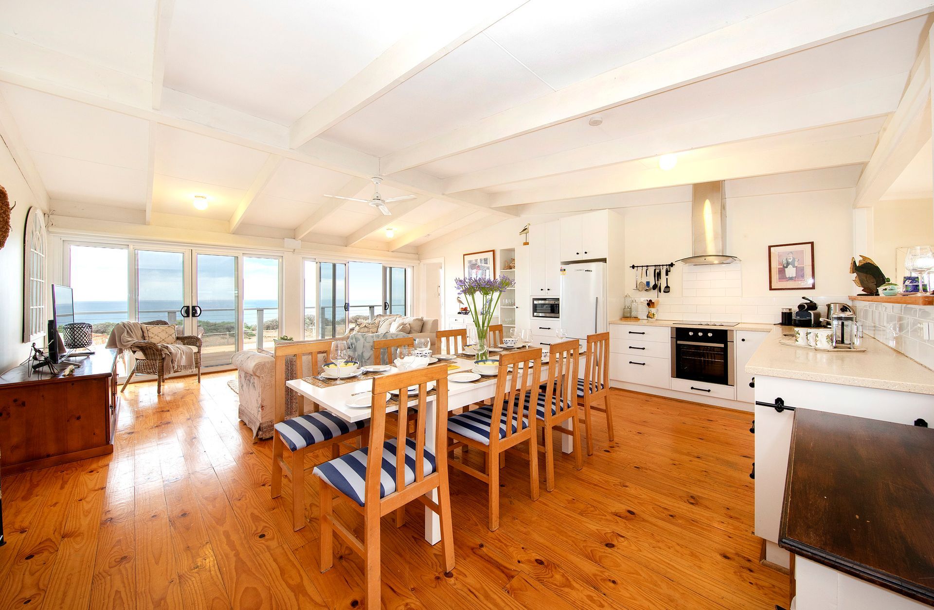 A living room with a dining table and chairs and a kitchen