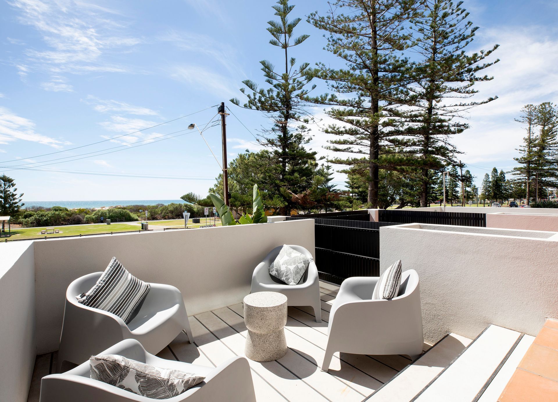 A large balcony with a table and chairs and a view of the ocean, Semaphore beach, Luxury Accommodation