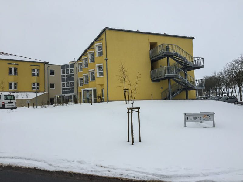 Ein großes gelbes Gebäude mit Treppen im Schnee