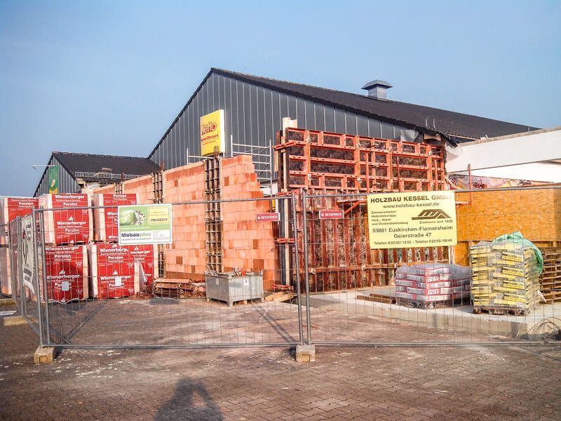 Ein im Bau befindliches Gebäude mit einem Zaun darum