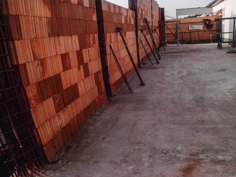 Auf einer Baustelle wird eine Ziegelmauer errichtet