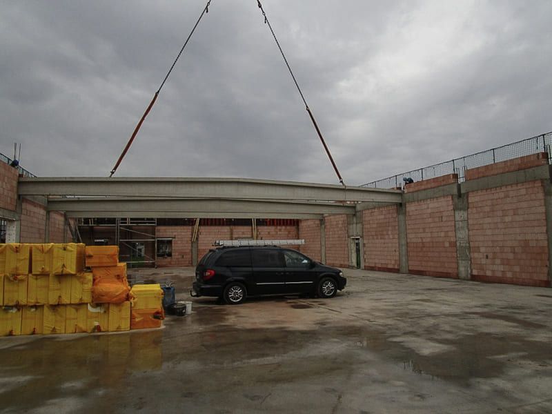 Ein schwarzer Lieferwagen steht vor einem im Bau befindlichen Gebäude
