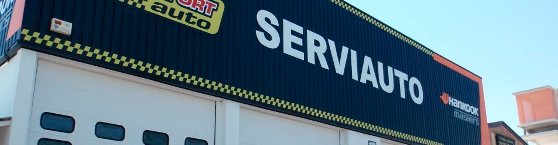 Un gran cartel en el costado de un edificio que dice serviauto