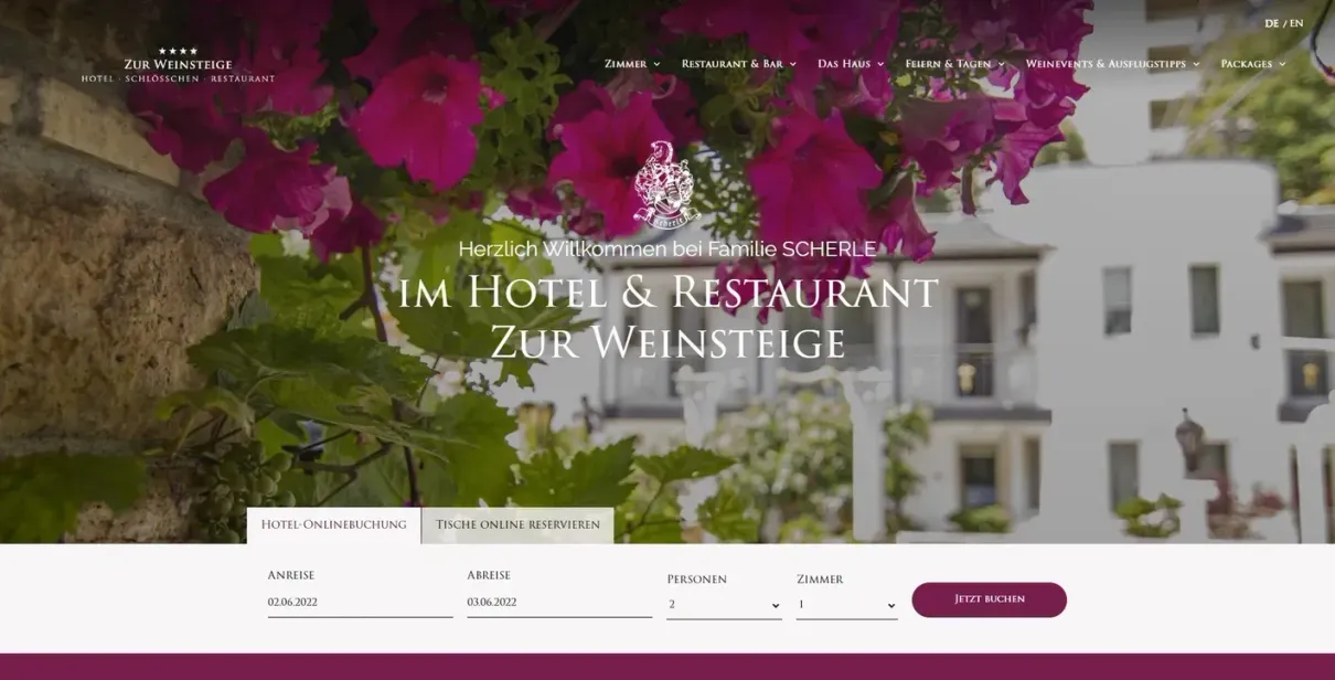 A website for a hotel and restaurant with purple flowers in the background.