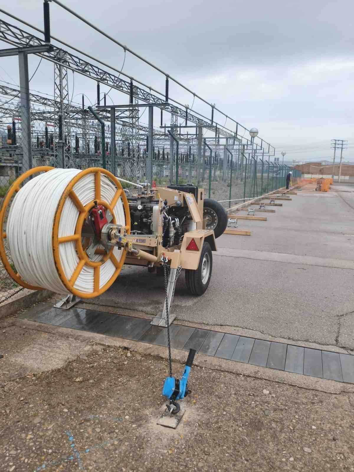 Panel de control eléctrico amarillo y verde en un entorno industrial, con varios medidores e interruptores.