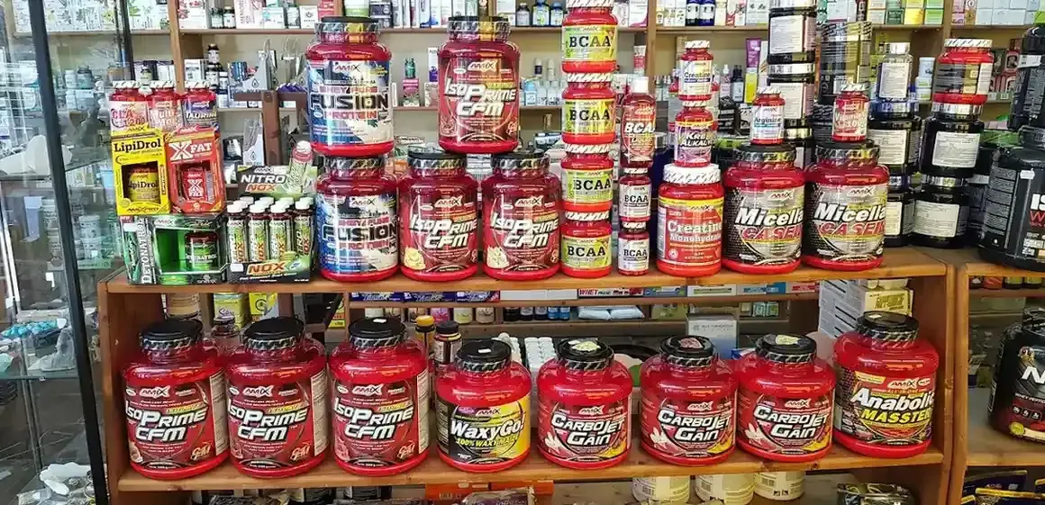 Los estantes de la tienda están repletos de envases de plástico rojo de diversas marcas y tamaños.