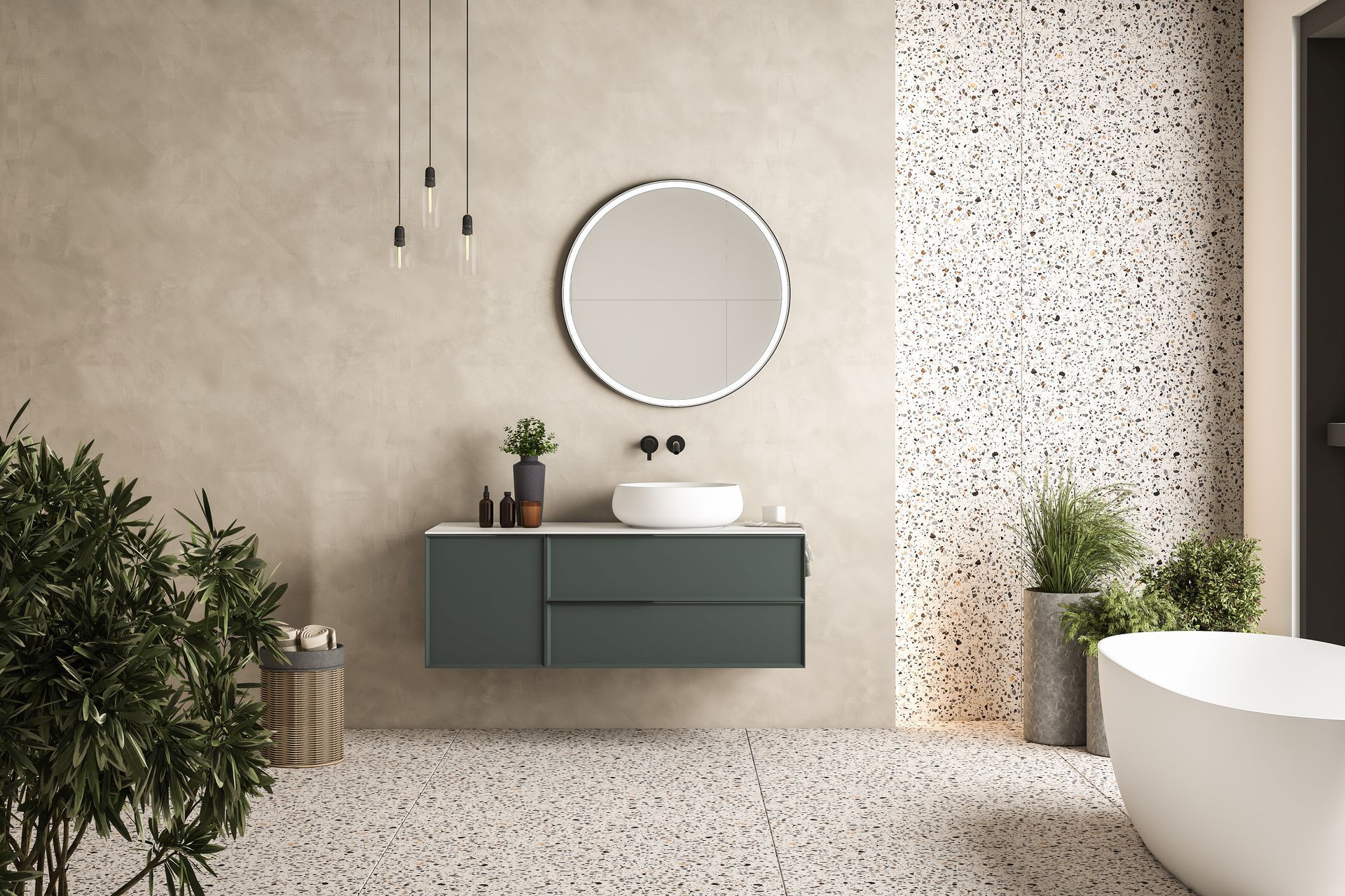 Salle de bains moderne avec meuble-lavabo vert, miroir rond, plantes et sol en terrazzo