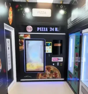 Maquina expendedora de pizzas artesanal que funciona las 24 horas, ubicado en un interior moderno y bien iluminado.