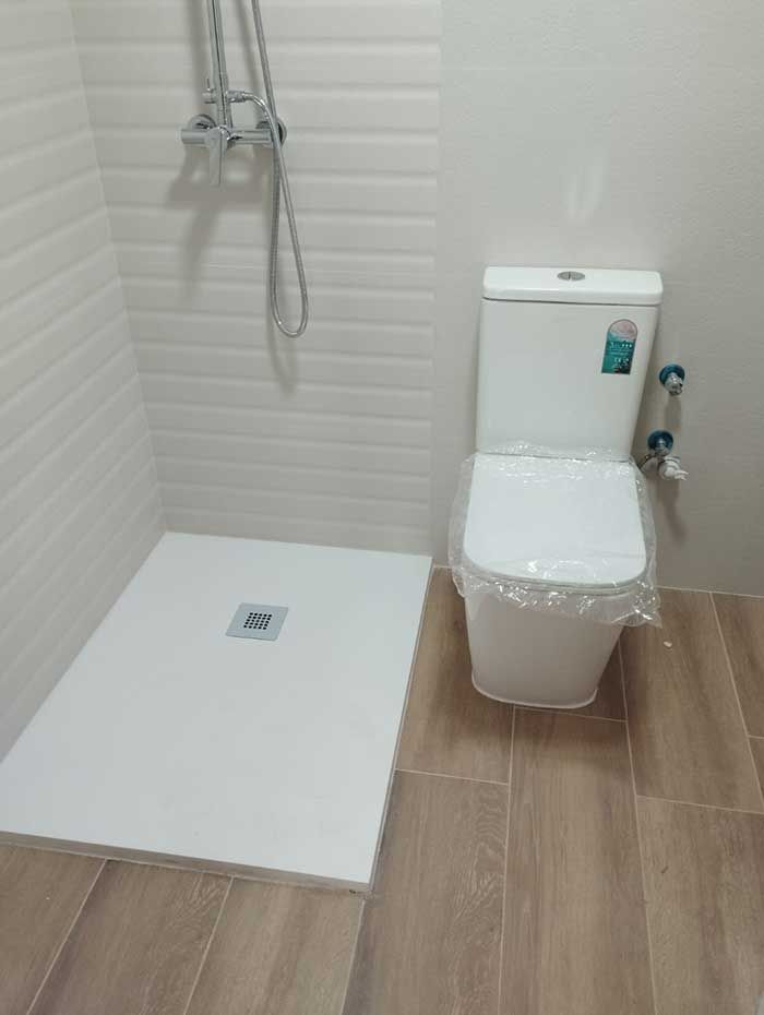 Un baño con inodoro y cabina de ducha.
