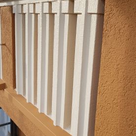 Eine Nahaufnahme eines weißen Geländers an der Seite eines Gebäudes.