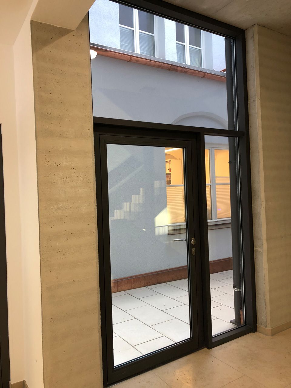 Ein Raum mit einem großen Fenster und einer Tür