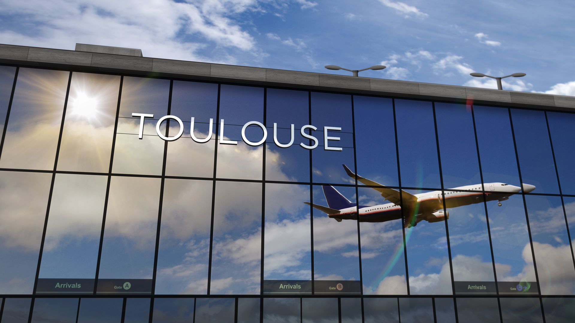 Aéroport de Toulouse avec un avion reflété dans les vitres