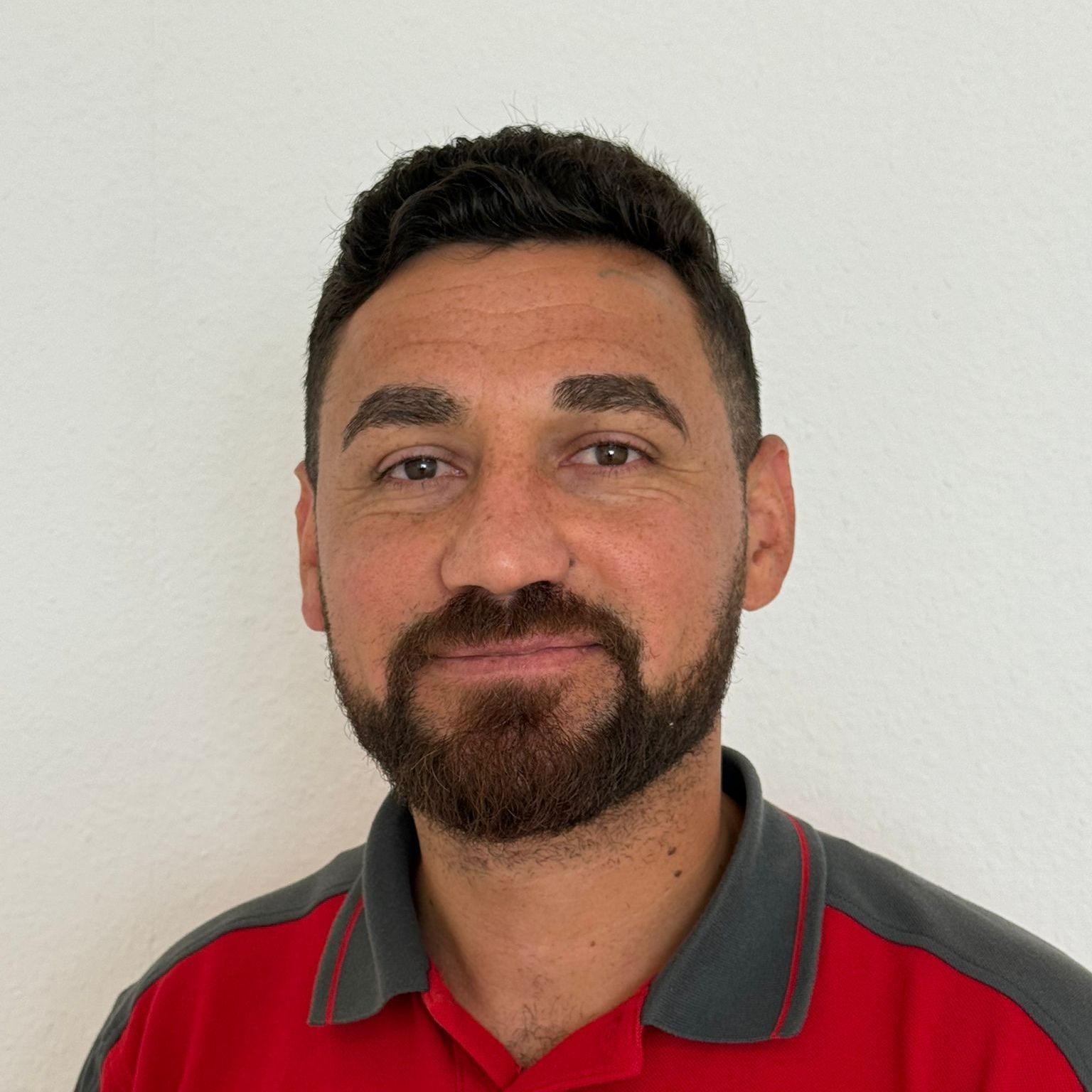 Ein Mann mit Brille und rotem Hemd steht in einem Kreis
