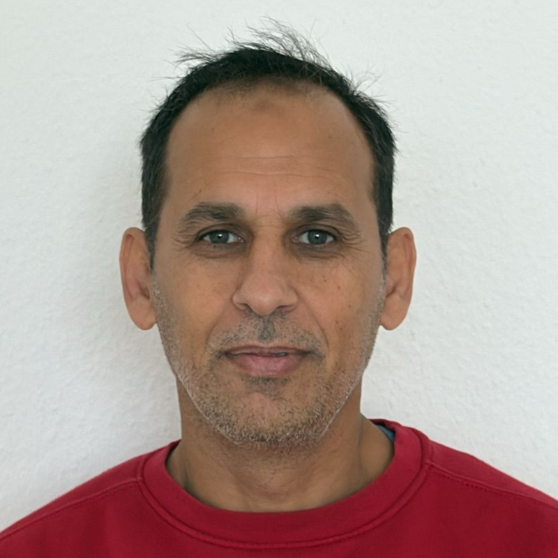 Ein Mann mit Bart trägt ein rotes Hemd