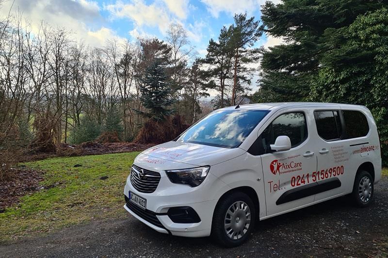 Ein weißer Lieferwagen steht am Straßenrand.