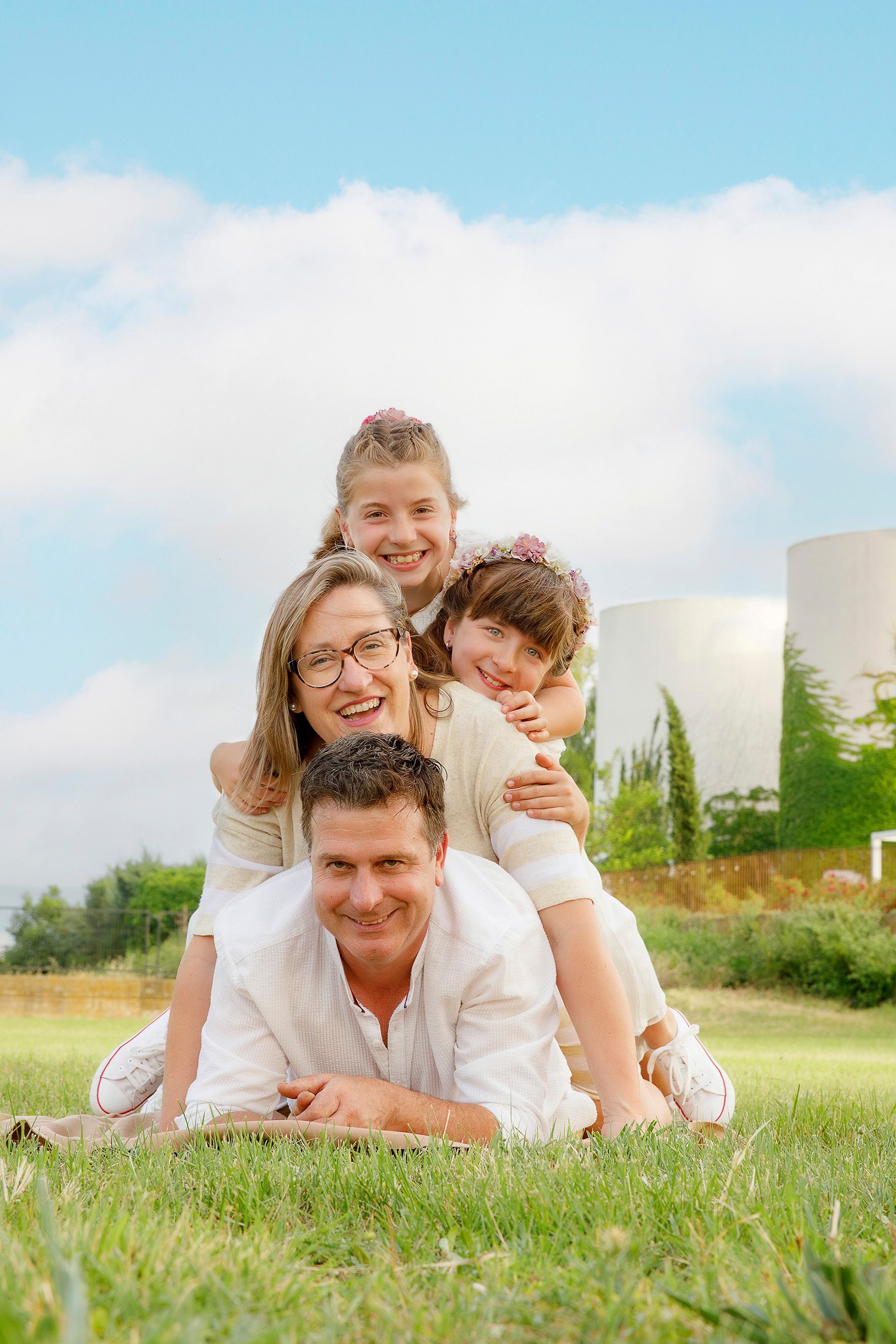 Una familia está acostada una encima de la otra en el césped.