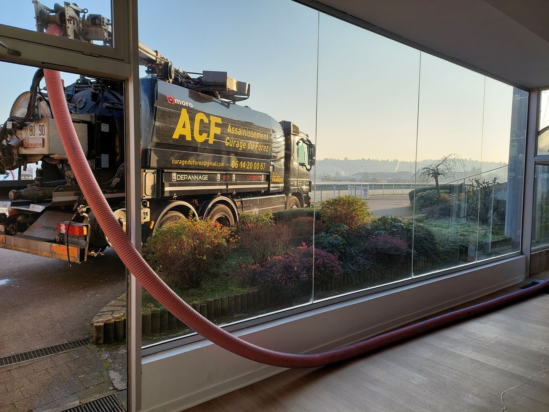 Un camion noir ACF réalise le pompage d'un bac à graisse à l'hippodrome de Saint-Galmier