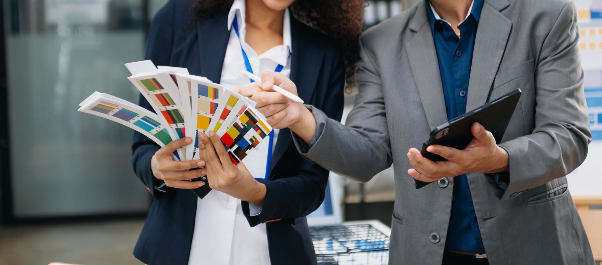 Woman and child looking at a tablet, both smiling. Woman has arm around child in a home setting.