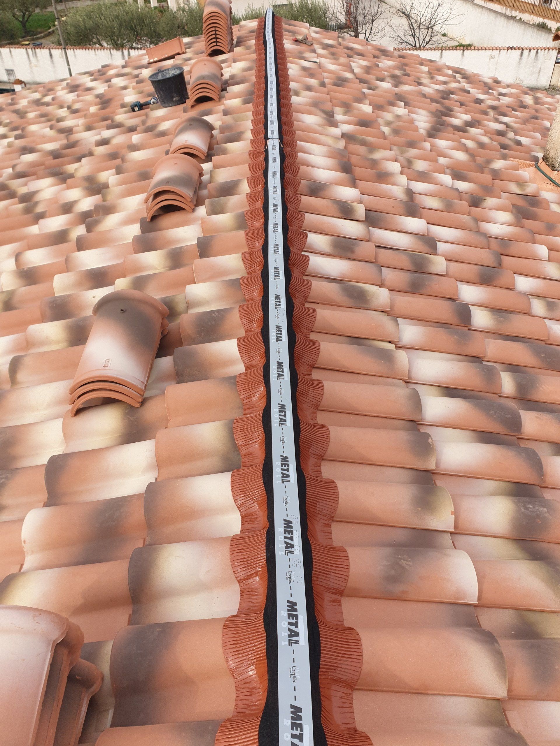 Pose de la zinguerie présente sous la ligne de faitage