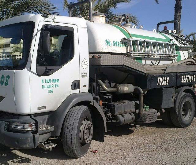 Un camión blanco con la palabra fosas en el costado.