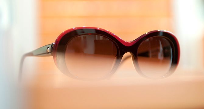 Eine Sonnenbrille liegt auf einem Holztisch.