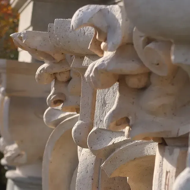 Hilera de gárgolas de piedra tallada con narices prominentes y superficies texturizadas.