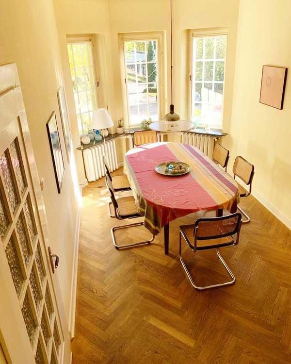 Ein Esszimmer mit einem langen Tisch und Stühlen