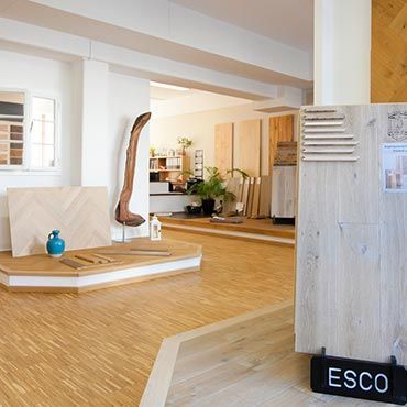 Ein Raum mit Holzboden und einem Schild mit der Aufschrift „Esco“
