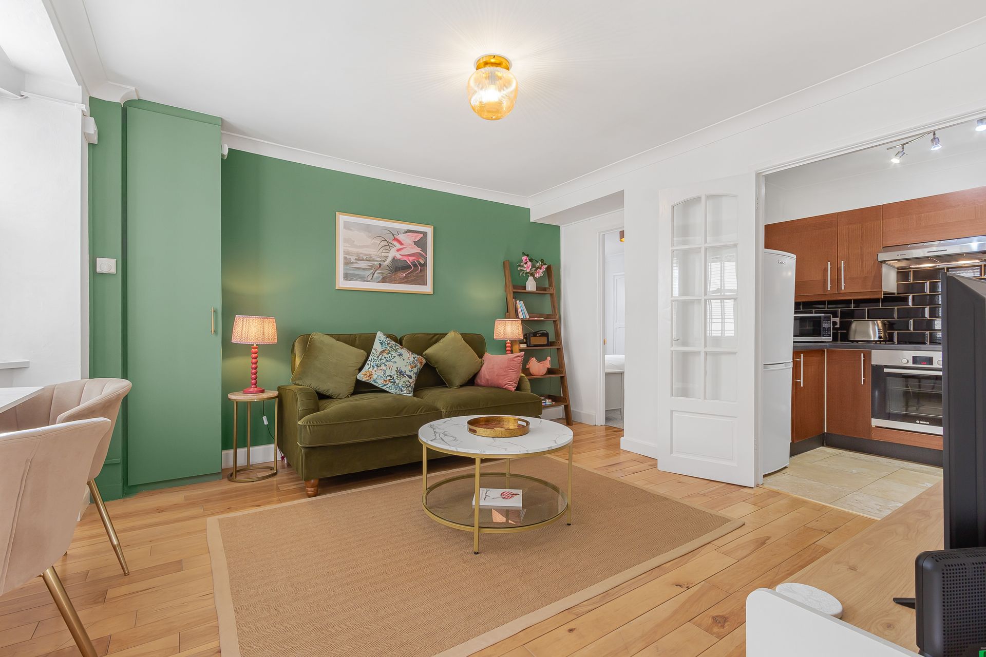 A living room with a couch , coffee table , and television.