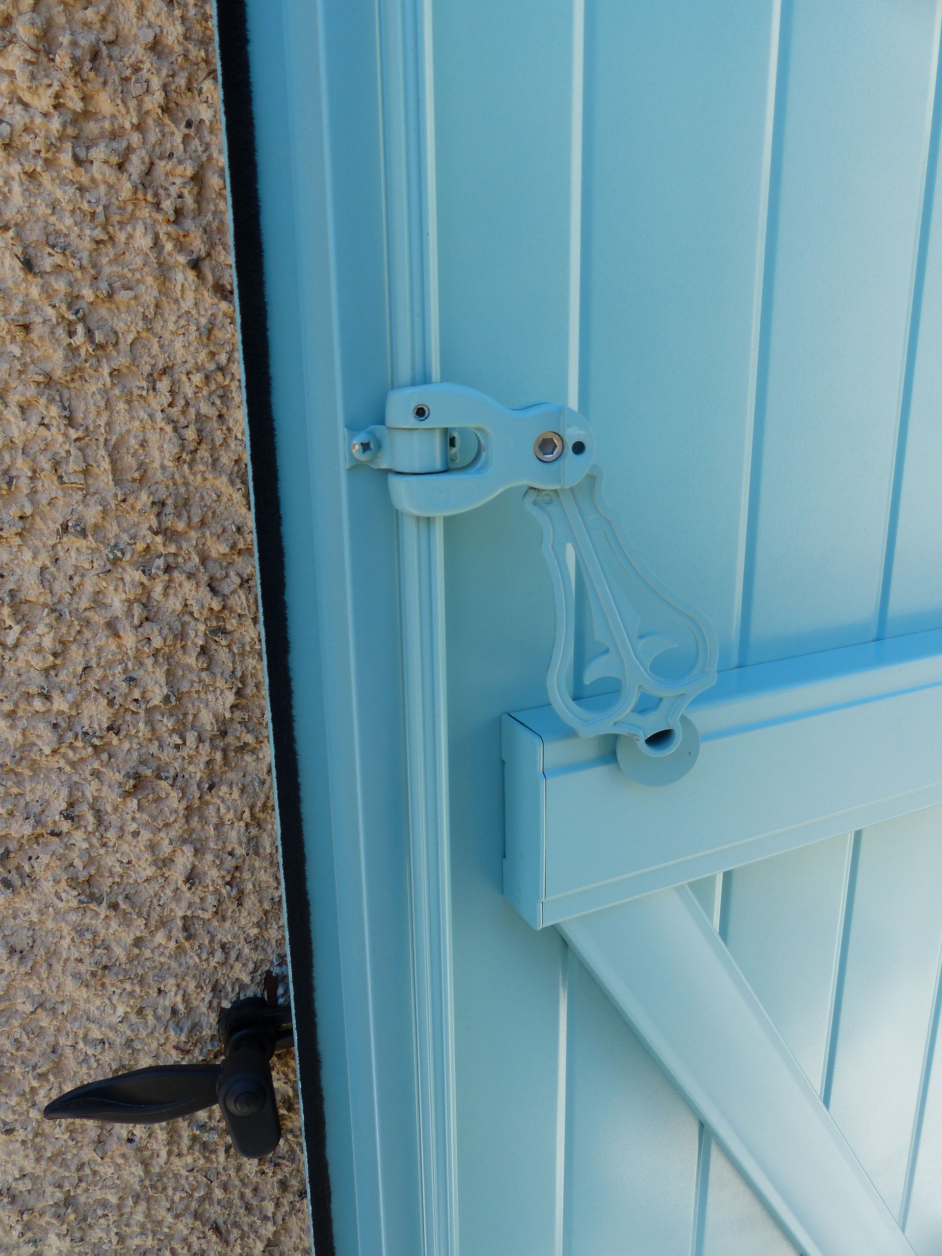 Gros plan sur la fixation d'un volet bleu