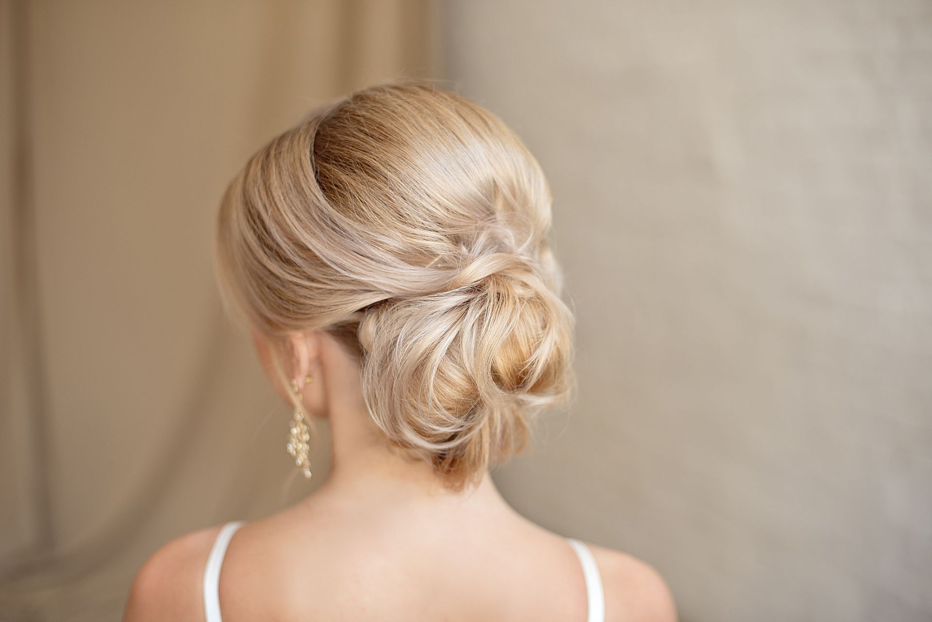 Femme blonde de dos avec un chignon