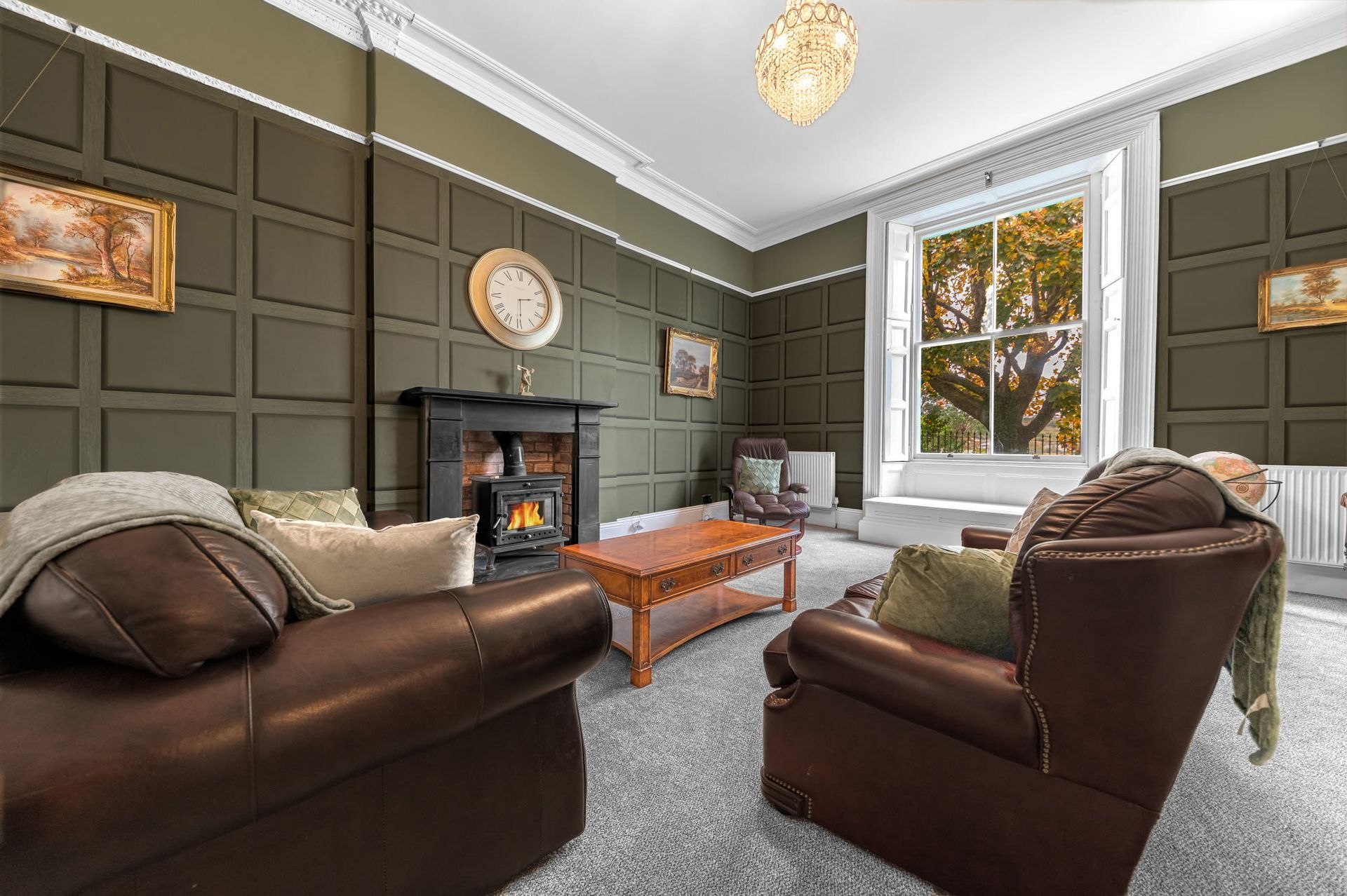 Twin beds in a room with navy blue and cream walls, yellow blankets, and decorative circles.