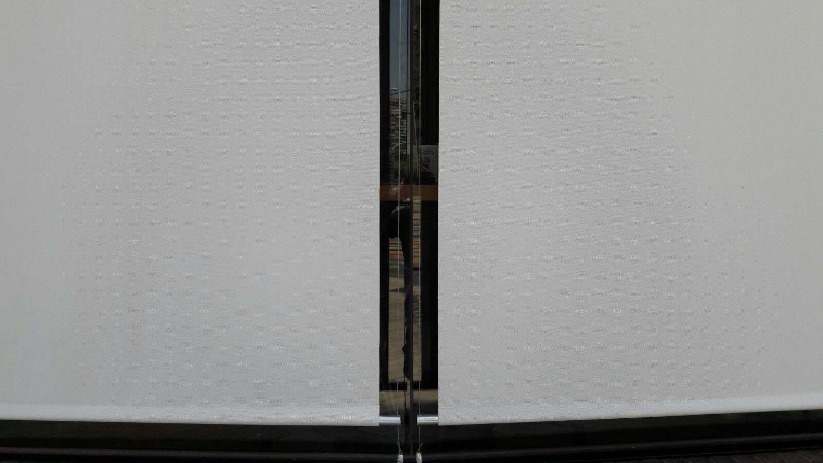 Un primer plano de una persiana blanca en una ventana.