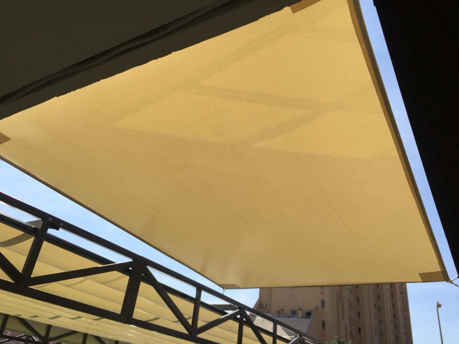 Un gran paraguas blanco cuelga del techo de un edificio.