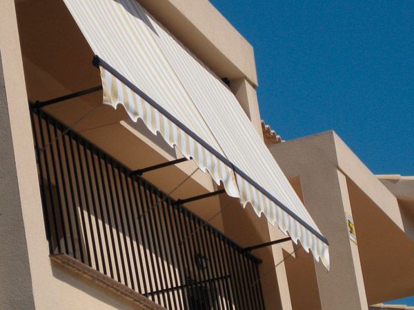 Un balcón con un toldo blanco encima.
