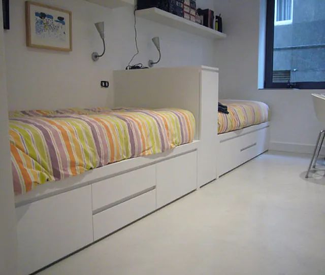 Un dormitorio con dos camas y una ventana.