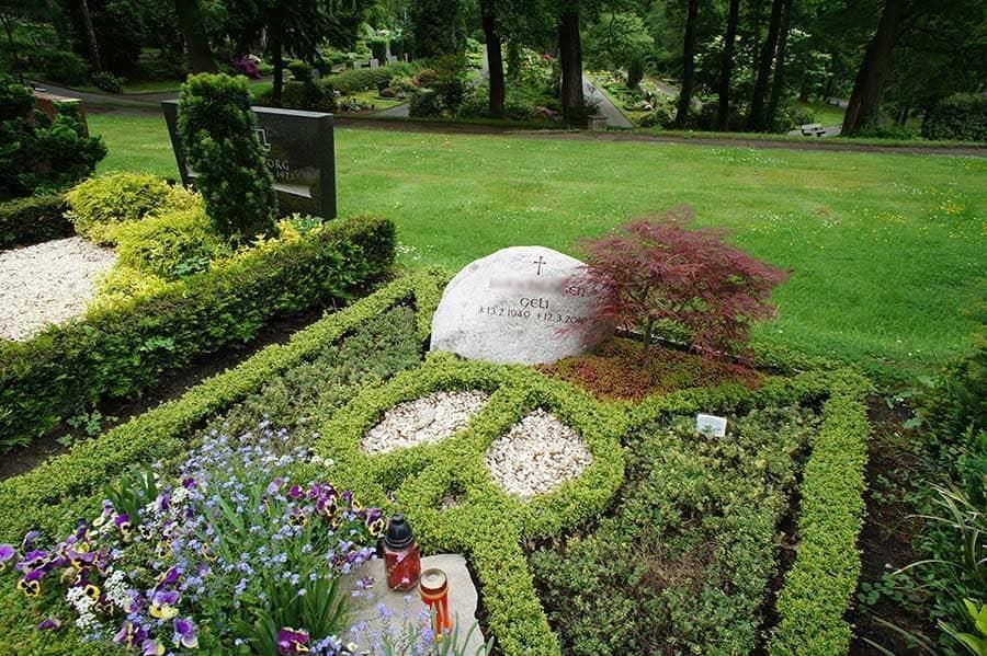 Ein Grab auf einem Friedhof mit Blumen und Kerzen